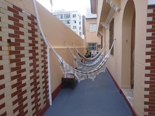 a hallway with hammocks on the side of a building at Pousada Acácia da Barra in Salvador