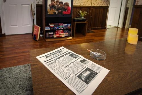 a newspaper sitting on top of a table in a living room at Immersive Stranger Things Experience in Clovis