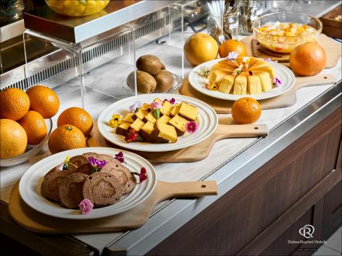 a buffet with several plates of food on a table at Daiwa Roynet Hotel Hakata Reisen PREMIER in Fukuoka