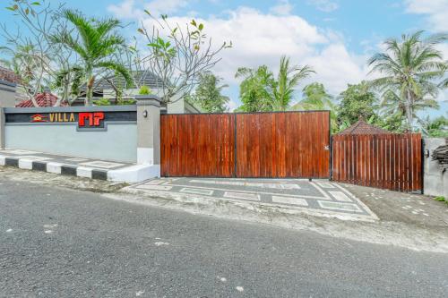 a wooden gate in front of a house at Belvilla Moksha Haven Pandawa BaliNearNirwana Garden Bali in Jembrana