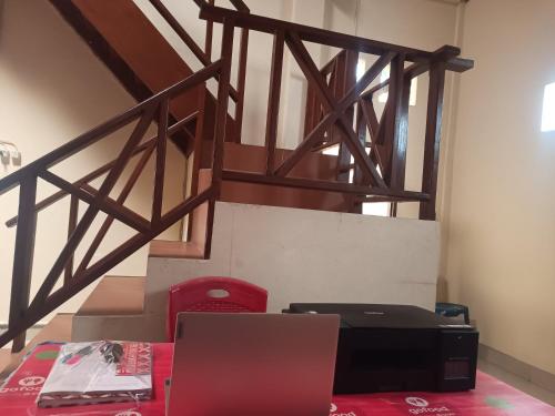 a room with a laptop and a desk with a laptop at Hotel O Lourdes Blessing Hill in Tomohon