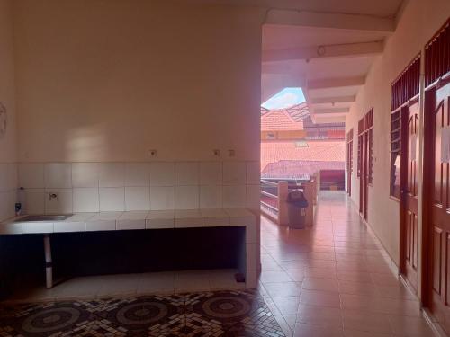 an empty hallway with a bench in a room at Hotel O Lourdes Blessing Hill in Tomohon