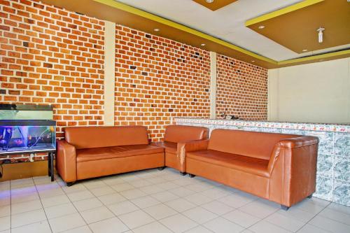 a waiting room with two chairs and a tv at Hotel O Sejahtera Syariah in Umbulan Tulungmeris