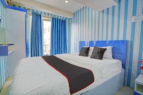 Ένα ή περισσότερα κρεβάτια σε δωμάτιο στο OYO Life Apartement Jarrdin By Fins Property