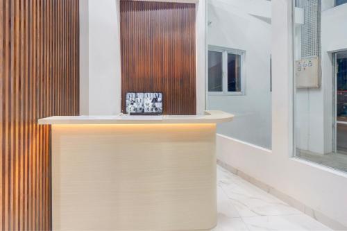 a counter in a store with a clock on it at Townhouse Oak Ancol in Jakarta