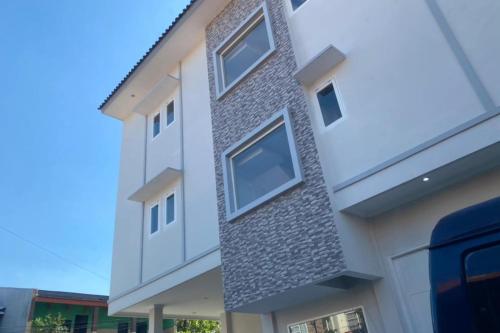 a building with a grey brick facade at Hotel O Dkp 32 in Surabaya