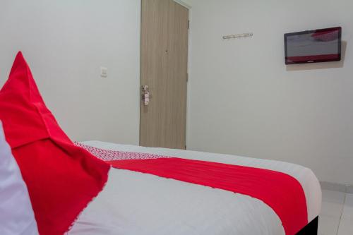 Ένα ή περισσότερα κρεβάτια σε δωμάτιο στο Hotel O 77 Guesthouse