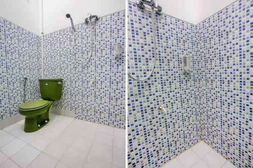 a bathroom with a green toilet and a shower at Collection O Tunas Plaza Residence in Bekasi