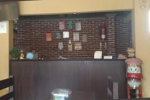 a bar in a restaurant with a brick wall at Hotel O Yume Guest House Near SDN 4 Batulayar in Midang