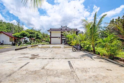 a motorcycle parked in front of a house at Hotel O Orchid Guest House in Yogyakarta