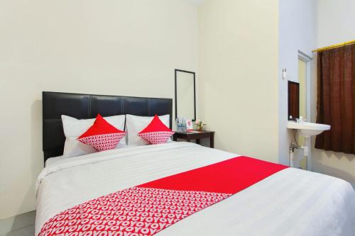 Ένα ή περισσότερα κρεβάτια σε δωμάτιο στο Hotel O Homestay Wak Gobenk