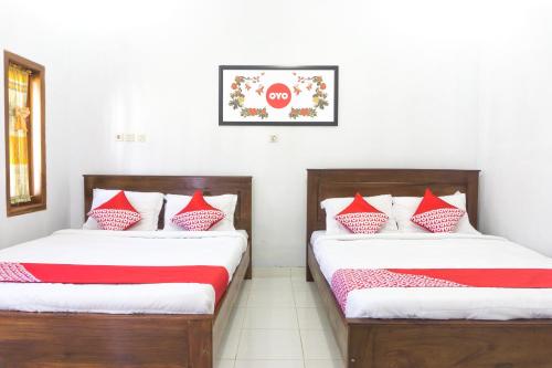 Кровать или кровати в номере OYO 801 Hansa Homestay