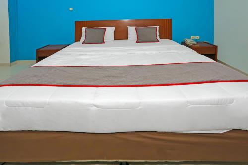 Ένα ή περισσότερα κρεβάτια σε δωμάτιο στο Townhouse OAK Hotel Fiducia Pasar Minggu