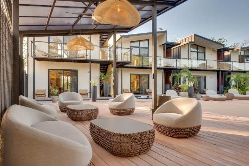 a patio with chairs and tables and a building at The Bungalows #6 - Boutique Hotel in Flamingo Beach - Top Level Studio in Playa Flamingo