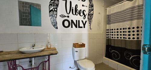 a bathroom with a toilet and a sink at The Upcycled Hostel Huacachina in Ica