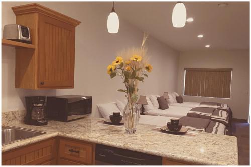 a kitchen with a vase of yellow flowers on a counter at Harbour Inn in Parker
