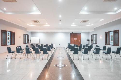 a conference room with chairs and a podium in it at Hotel O Bunga Karang Hotel in Bekasi