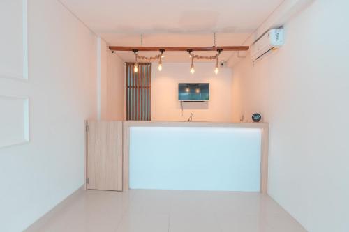 a white room with a large white table in the middle at Hotel O Apartement Sentul Tower in Bogor