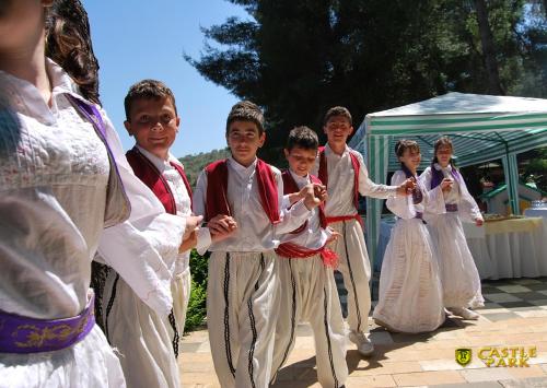 a group of children in traditional dances at a wedding at Hotel Castle Park in Berat