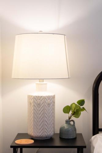 a lamp on a table with a plant on it at Experience Center Conway I 4 Seasons of Fun in Conway