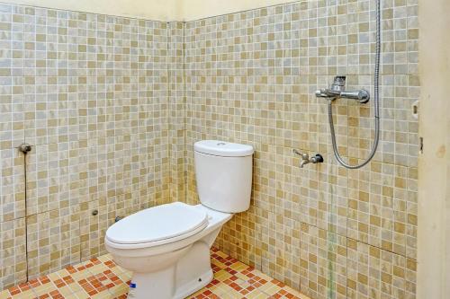 a bathroom with a toilet and a shower at OYO Life 91984 Taufik Kost Syariah in Prabumulih
