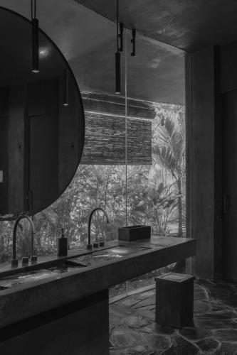 a bathroom with two sinks and a large mirror at Charming Tulum Getaway in Prime Location in Tulum
