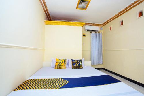 Ένα ή περισσότερα κρεβάτια σε δωμάτιο στο Hotel O Buana Jaya Guest House
