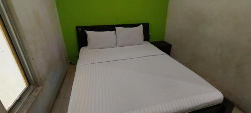 Кровать или кровати в номере Hotel O Azwa Gh Katingan Near Lapangan Sepak Bola Pegatan Hilir