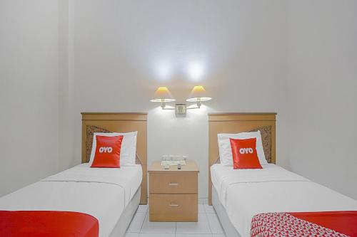 Ένα ή περισσότερα κρεβάτια σε δωμάτιο στο OYO Life 90589 Palem Garden Hotel