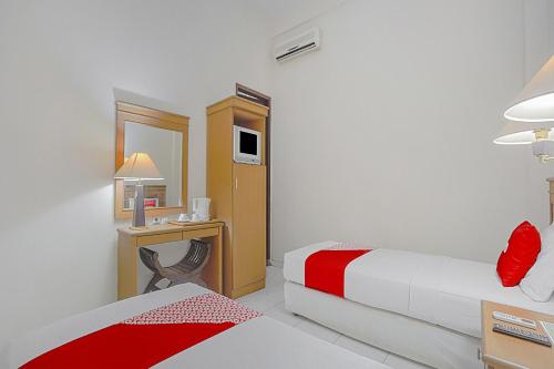 Ένα ή περισσότερα κρεβάτια σε δωμάτιο στο OYO Life 90589 Palem Garden Hotel