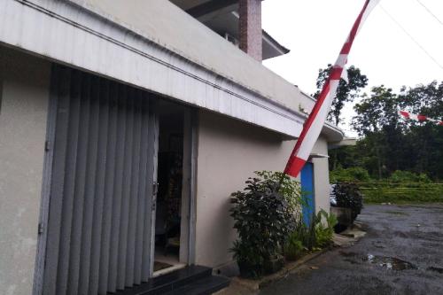 a red pole sticking out of the side of a building at Hotel O Spring Homestay in Jember