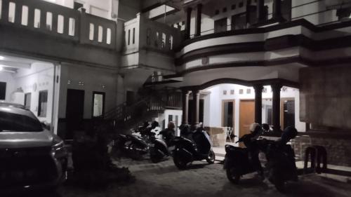 eine Gruppe von Motorrädern, die neben einem Gebäude geparkt werden in der Unterkunft OYO Life 93160 Kost Jenny Karawang in Karawang