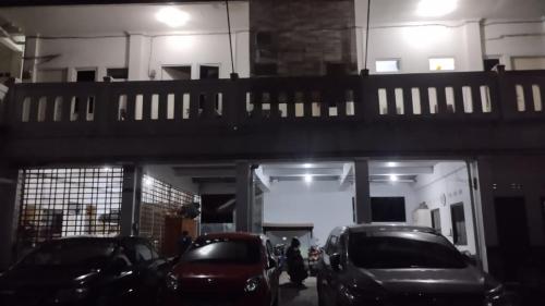 ein Parkplatz mit Autos unter einer Brücke geparkt in der Unterkunft OYO Life 93160 Kost Jenny Karawang in Karawang