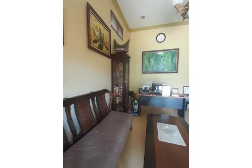 a living room with a couch and a table at Hotel O Family Homestay Syariah in Medan