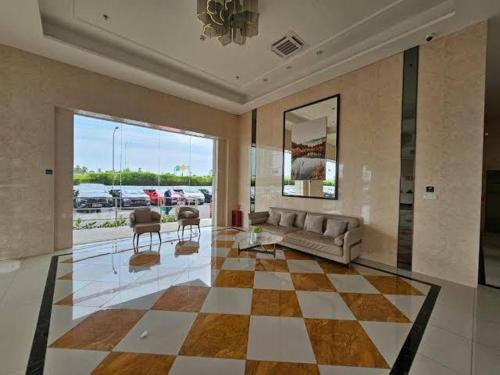 a living room with a couch and a table at Capital O 93529 September House in Samporo