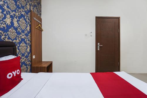 Rúm í herbergi á OYO D'lima Guest House Sub