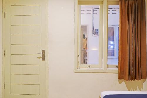 a room with a white door and a window at OYO Life 91504 De Vila Ungu Syariah in Ciamis