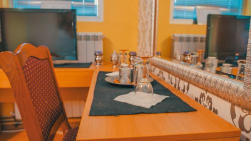 a table in a restaurant with a plate of food at Guest House MK Star in Belgrade