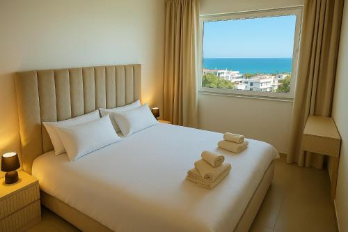 a bedroom with a bed with two towels on it at Tanger City Center Residences Suites & sea view in Tangier