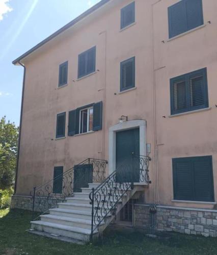 a building with stairs and a door on it at Mansarda Mainarde in Capracotta