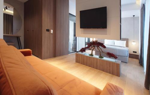 a bedroom with a bed and a flat screen tv at Keta Hotel & Spa - Mavrovo in Mavrovo