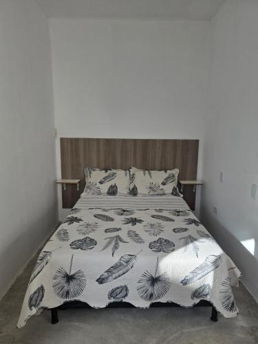a bed with a bedspread with fish on it at Espaço Bom Viver in Rio das Ostras