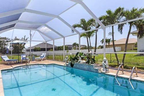a swimming pool with a white canopy over it at Pool Modern South West Cape Casa Del Mar in Cape Coral