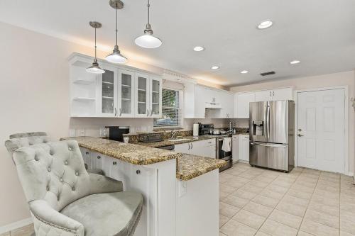 a kitchen with white cabinets and a counter top at Pool Modern South West Cape Casa Del Mar in Cape Coral