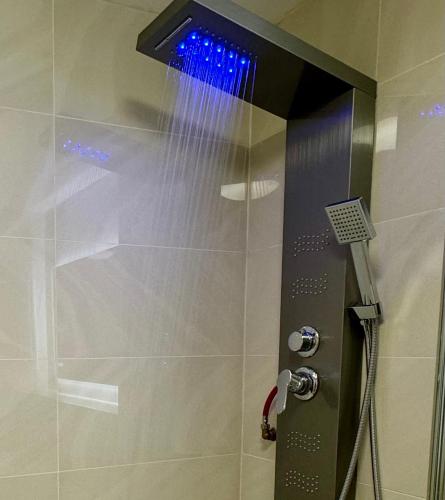 a shower with blue lights in a bathroom at City View Apartments in Manchester