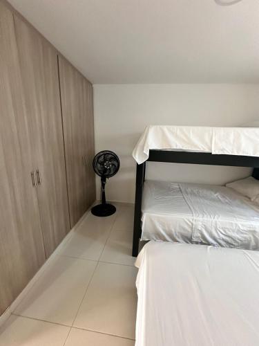 a room with two bunk beds and a fan at Casa Quinta in Villavicencio