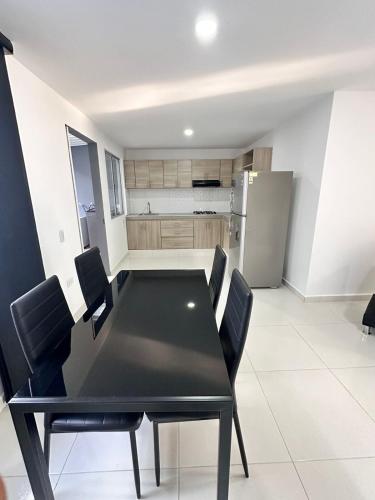 a black dining room table and chairs in a kitchen at Casa Quinta in Villavicencio
