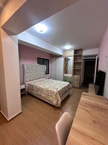 a bedroom with a bed and a chair in it at Vale's Cottage in Huaraz