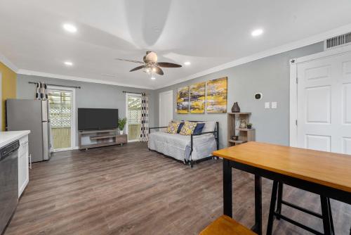 a living room with a couch and a ceiling fan at Cozy & Spacious 1BR in Montrose Walk to Top Attractions in Houston