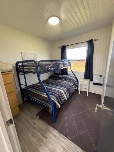 a bunk bed in a room with a window at PEI Cottage Rental in Borden-Carleton